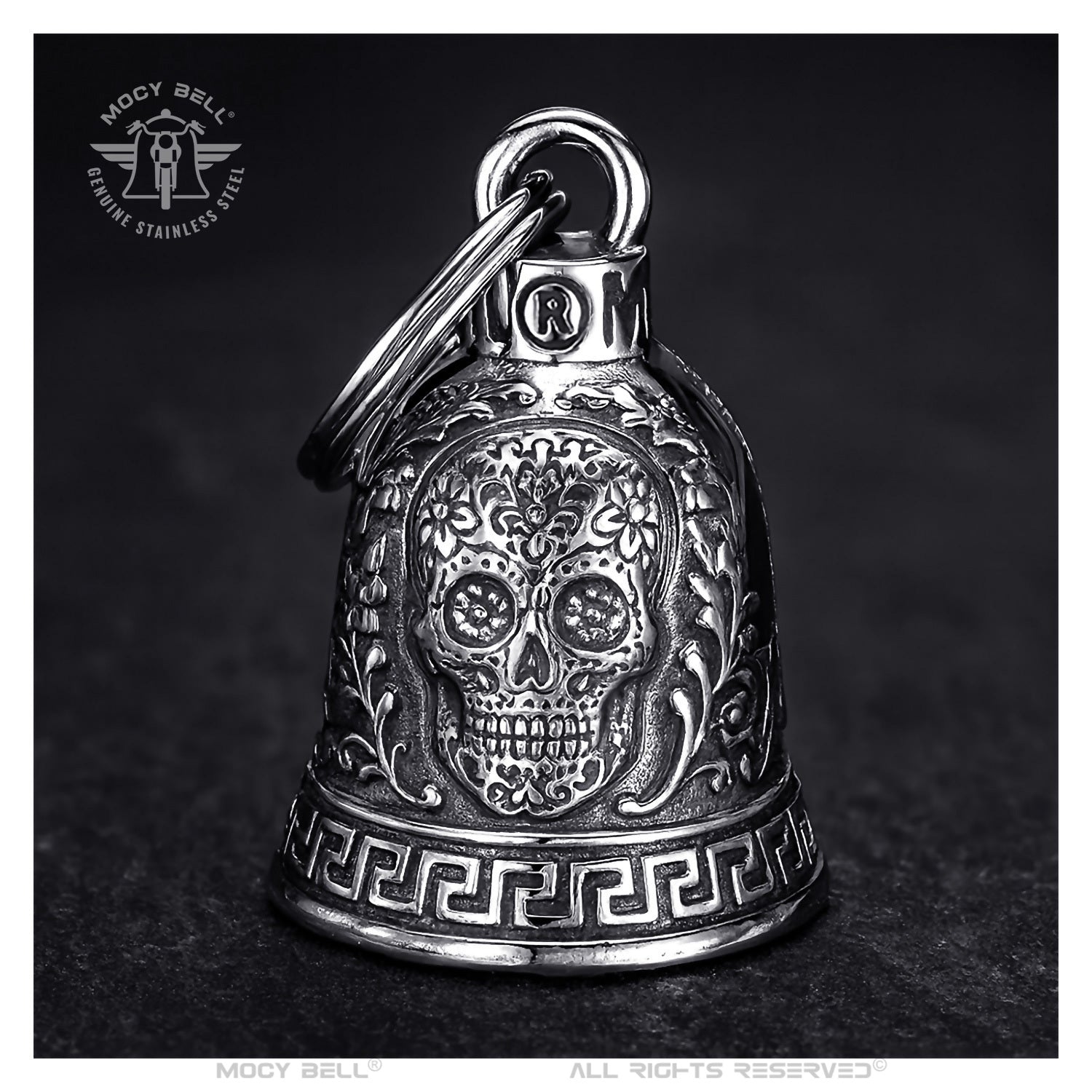Clochette moto crâne mexicain Calavera argentée, acier 316L, symbole de sécurité, tradition biker et talisman protecteur.