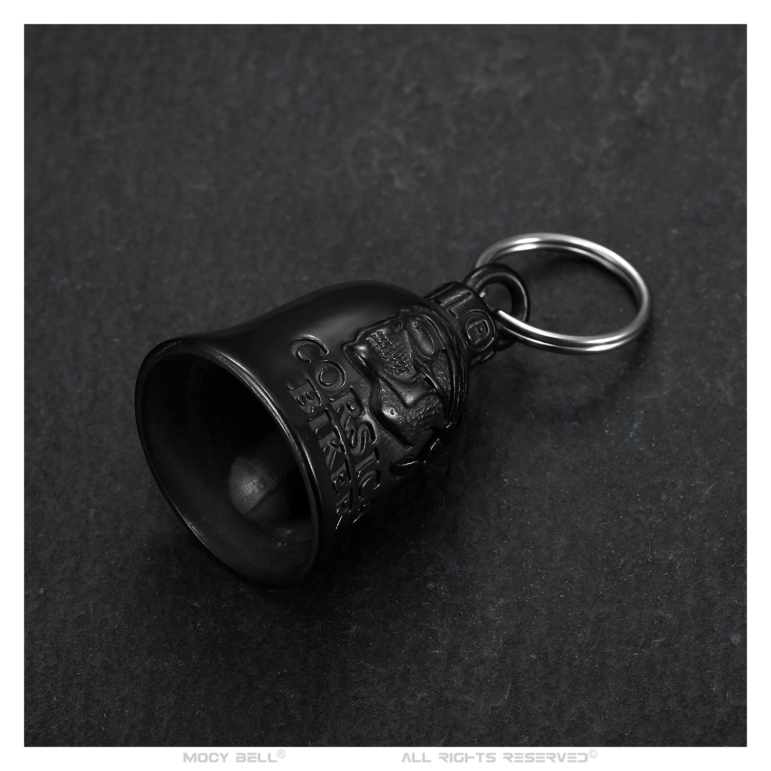 Sonnette moto Corsica Biker noire titane photographiée de face, gravure tête de mort et texte Corsica Biker visible sur fond blanc